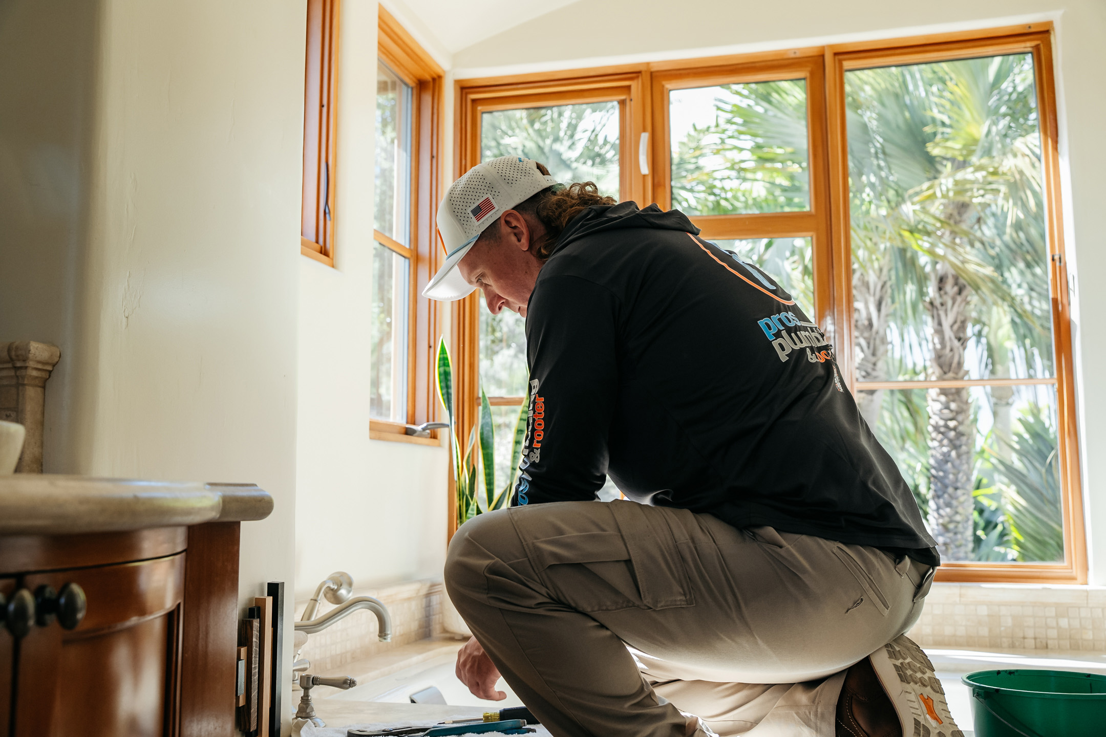Licensed plumber repairing a bathroom faucet in Southwest Florida